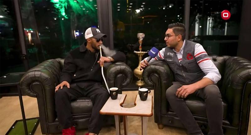 Before the Iraq Concert: Mohamed Ramadan Conducts a TV Interview with a Hookah