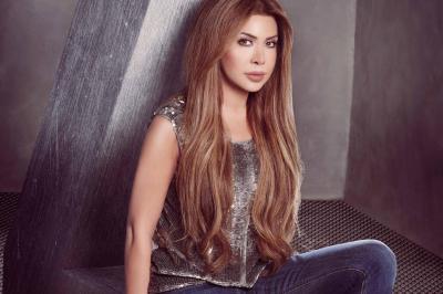 Nawal El Zoghbi Appears in a Gold Dress from the Filming Location of Her New Music Video "Aqli Waqaf"