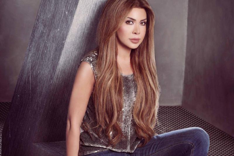 Nawal El Zoghbi Appears in a Gold Dress from the Filming Location of Her New Music Video 