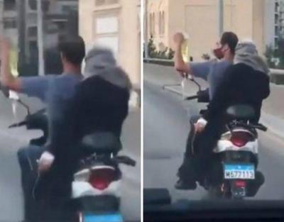 A Lebanese Man Rides His Motorcycle with One Hand to Help His Sick Wife
