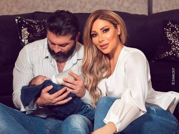 Yazan Al-Sayed Feeds His Child While His Wife Asks the Audience