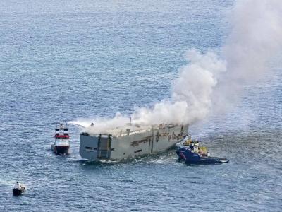 Title: Dutch Authorities Tow Burning Cargo Ship to Port