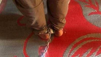 Father Binds Son with Iron Chain