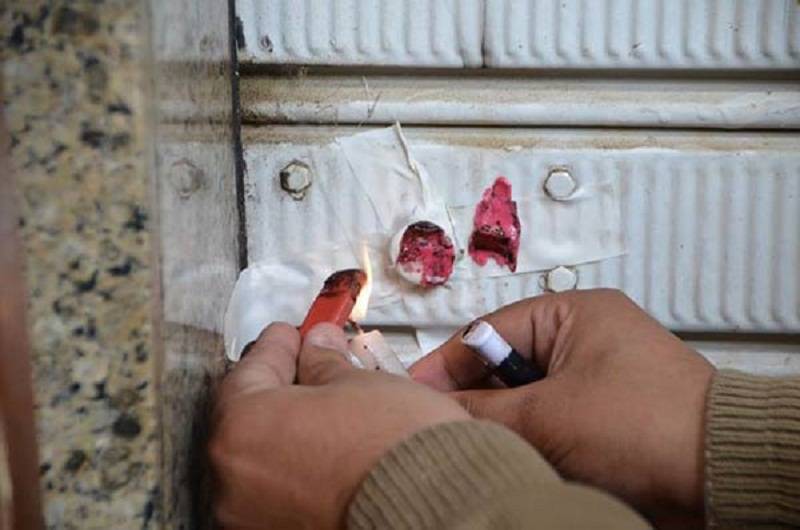 Closure of Supermarket in Ain al-Dalab with Red Wax