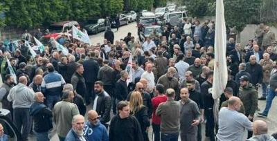 Popular Reception of Pascal Sleiman's Funeral Procession with Flags, Tears, and Rice
