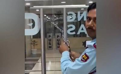 Title: Video Shows Manager Locking Office Door to Prevent Employees from Leaving
