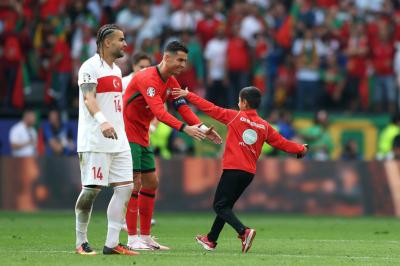 Title: Young Fan Evades Security to Take Selfie with Ronaldo