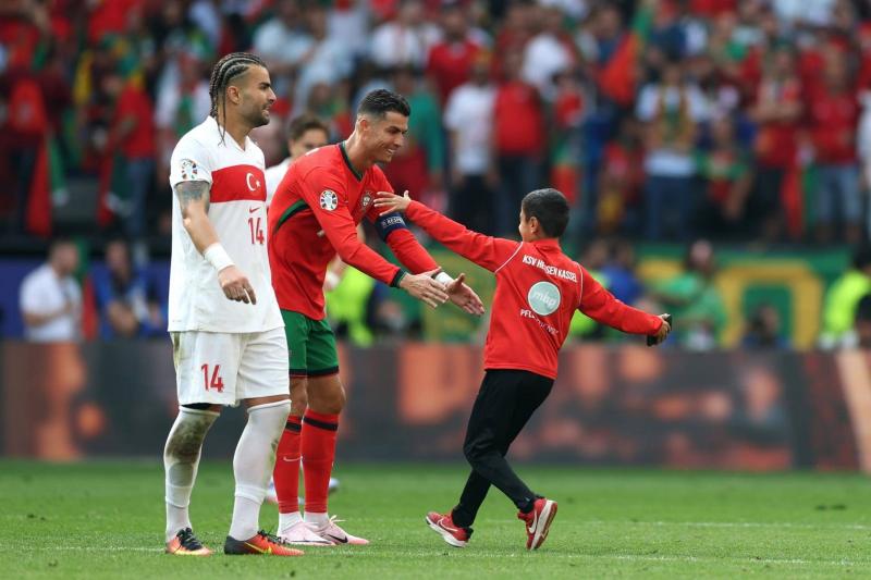 Title: Young Fan Evades Security to Take Selfie with Ronaldo