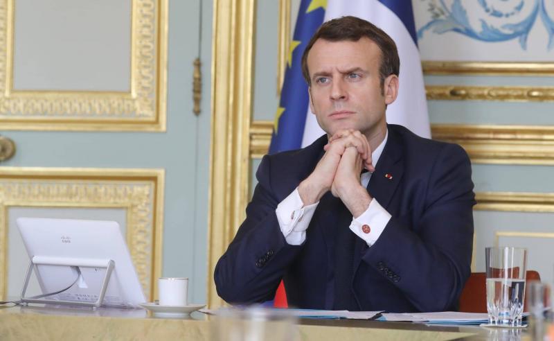 Title: Despite His Party's Setback in French Elections, Macron Strolls with His Wife